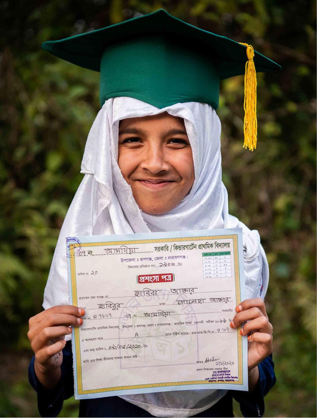Picture of a student with her certificate in the graduation ceremony